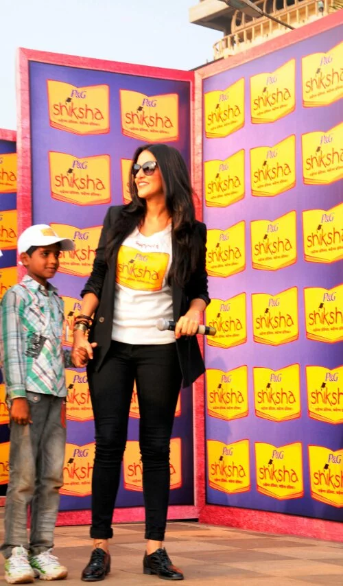 Neha Dhupia With a child at Walk for the Love of Shiksha